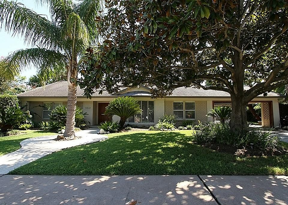 Professionally Landscraped Yard is enhanced by the Mature Trees.