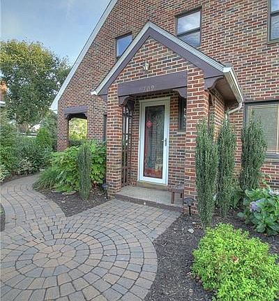 Note the maintenance free exterior, geometric designed brick walkway and covered front porch.  Sidewalk leads to the covered sid
