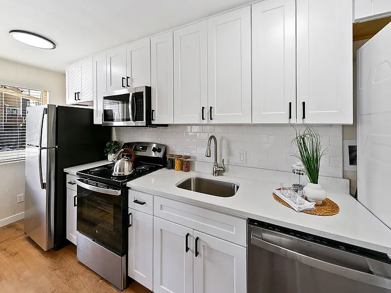 Quartz countertop, undermount sink, and subway tile backsplash.