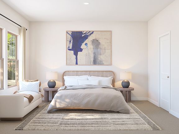 Primary suite with plush carpeting and private primary bath