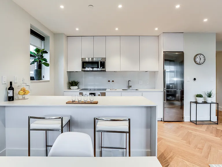 Custom kitchen with quartz countertops, hardwood floors and Bosch appliances and an island