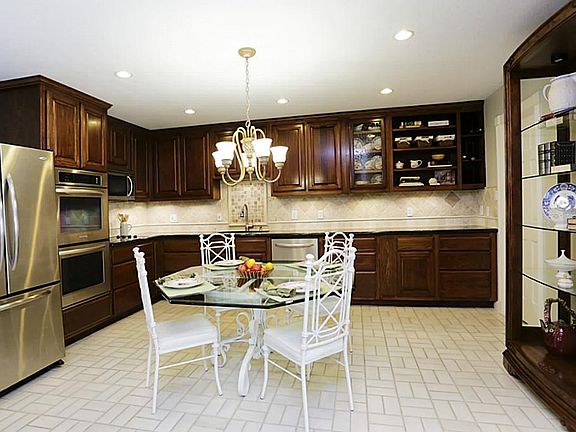 Gorgeous kitchen with granite counter tops, coordinating tile backsplash and stainless steel applian