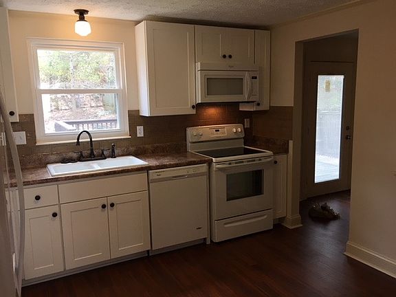 Renovated kitchen with brand new appliances and subway tile