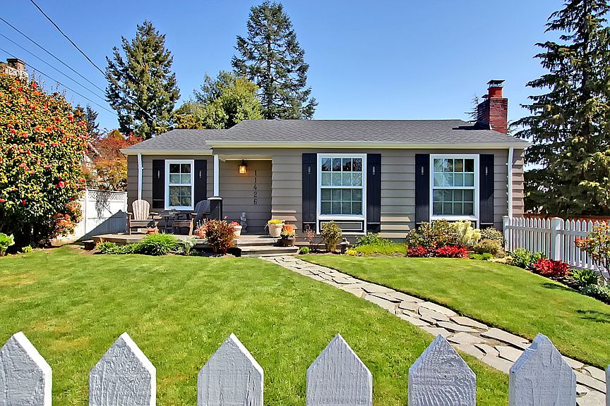 White picket fence, nice landscaping and an in-ground irrigation system. Exterior of house newly painted.