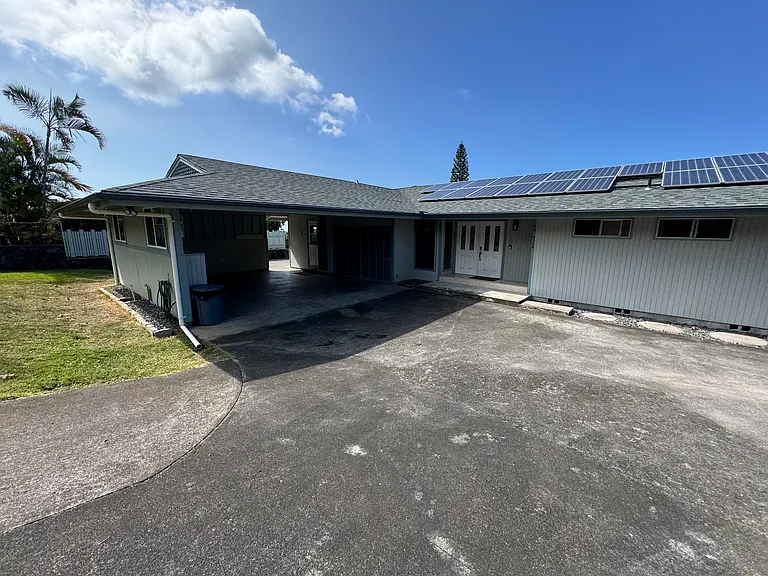 Semi enclosed carport 524 sq ft. Extra open parking. View of solar panels, makes for great electricity rates.