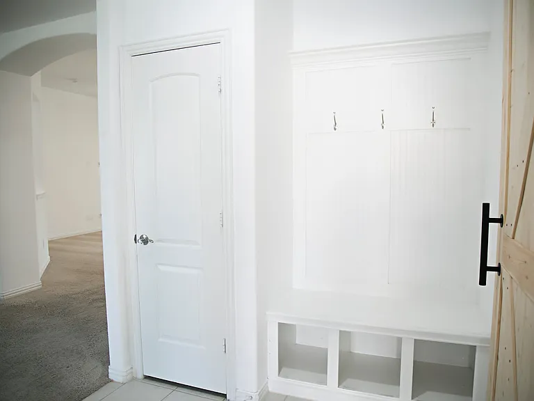View from the garage door of mudroom/coat area.