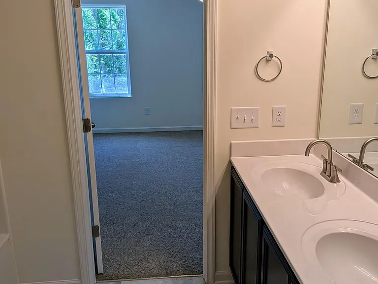 The owner's suite bathroom includes a double vanity, offering extra counter space and functionality.