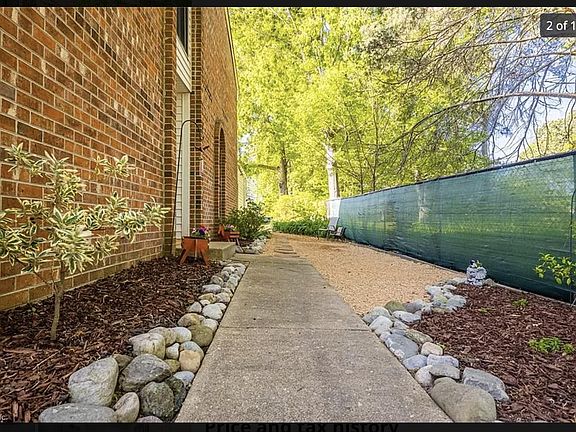 Private walkway to access the main entrance to the home. Surrounded by woods offering privacy.