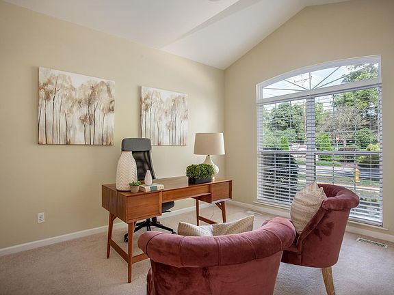 Office/den with built-in bookcases and french doors.