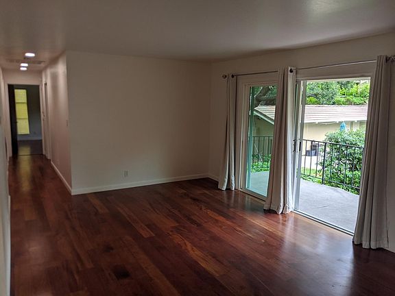 View to hall and bedrooms from living room. Light blocking drapes.