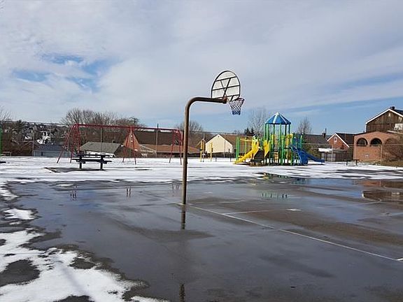 Playground and basketball courts right across the street from house.