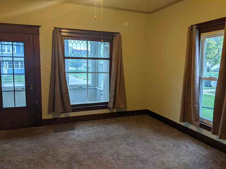 Beautiful front room, original leaded glass window in front, all other winders newer. Wall color is a light almond (see next picture). Lots of natural light.