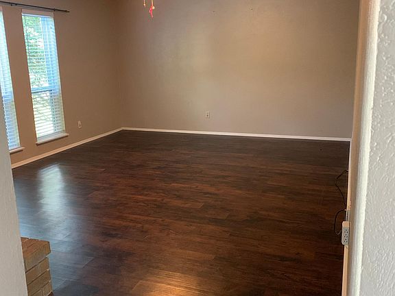 Nice size living room with new flooring, wood burning fire place