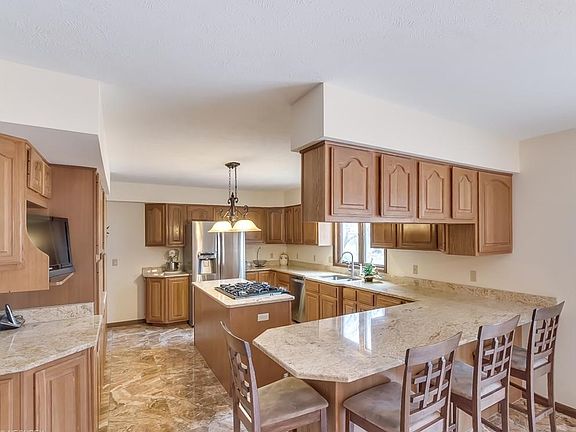 Large eat-in kitchen with new ceramic flooring, new granite countertops and new stainless steel appliances. Loads of cupboard space