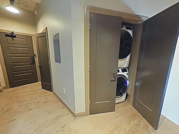 Main door, larger double door front closet, and double door wash and dry closet