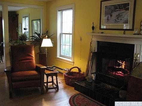 Living room with wood burning fireplace.