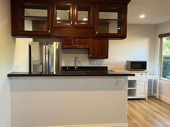 Kitchen showing coffee station/storage along with microwave