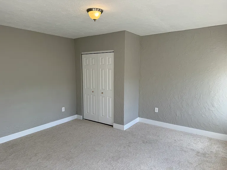 Primary Bedroom with closet build out, new carpet and fresh paint. Plenty of natural light.