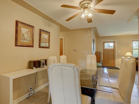 Dining room with ceiling fan.