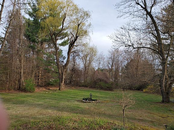 half acre back yard with flower beds