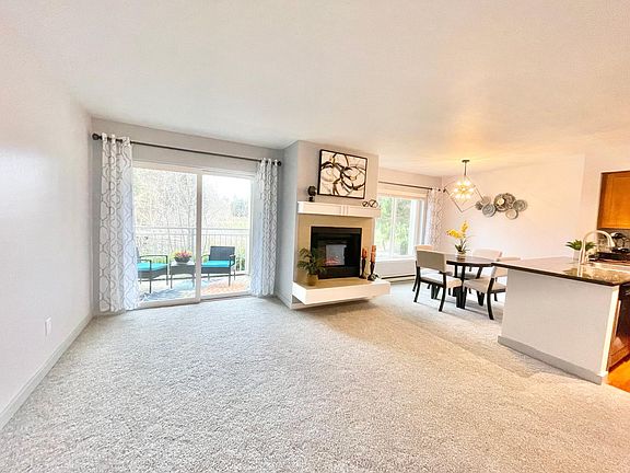 Open concept living room, dining room and kitchen - all have golf course views.