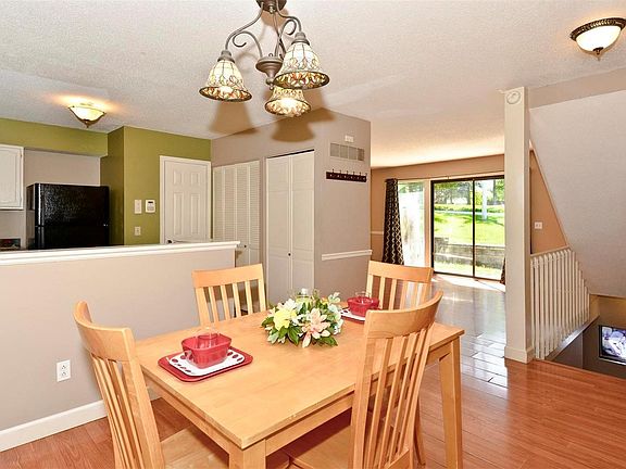 Another View of the Dining Room, Kitchen, Down the Steps to the Finished Lower Level and a Peek into the Living Room.