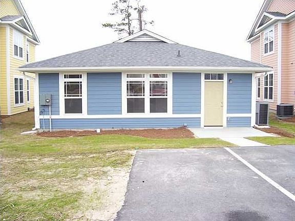 Back of Home with Two Parking Places per Unit 