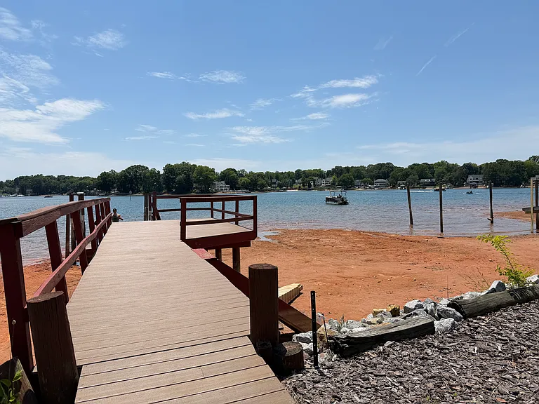 Private wooden dock with direct access to the water, perfect for boating, fishing or relaxing with views.