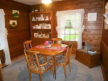 Dining room also in knotty pine, 13x11.