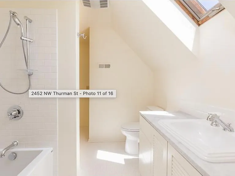 Bathroom with skylight, tub/shower, updated fixtures and tile throughout.