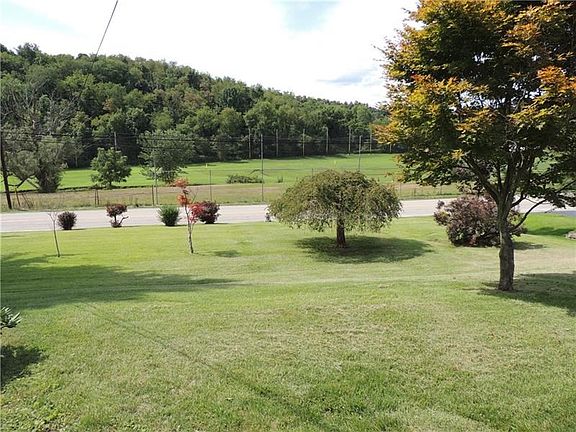 This view shows the spacious and groomed front yard from the front porch.  So much room for all of your outdoor activities.
