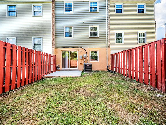 Outside backyard showing fence, patio and back od the house