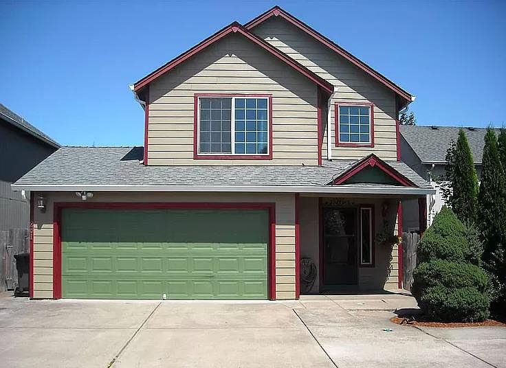 Double car garage with large cabinets for storage.