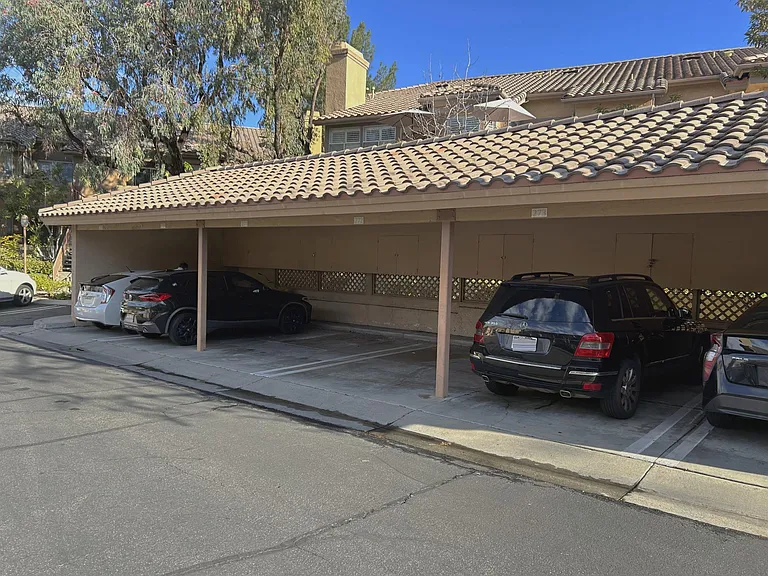 Condo has an assigned carport space and storage. If more cars are needed for more residents, security hands out parking stickers allowing cars to park in any open spots not in carports. You also get temporary tags that hang from car mirrors to authorize y
