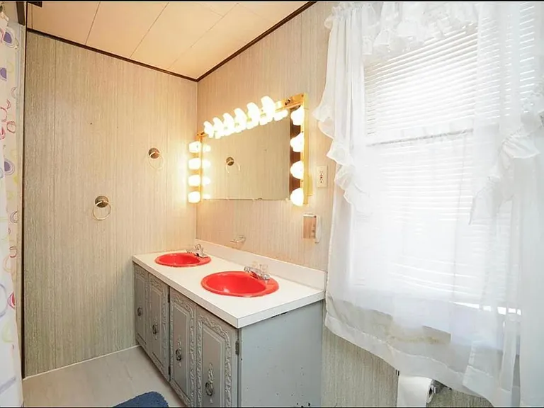 Double sinks and hollywood-style lighting plus a fan and heat make this full bathroom work extra hard to make your day start right!