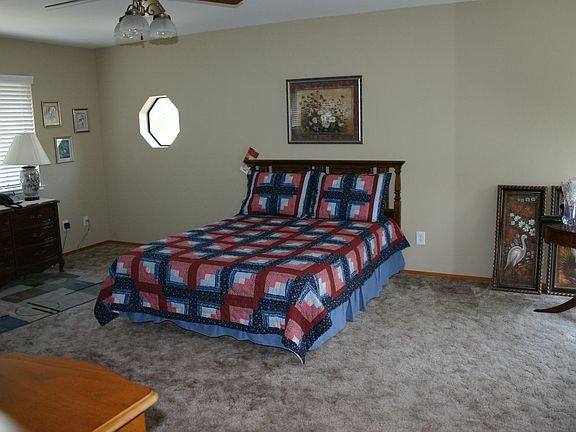Upstairs master bedroom with small balcony looking onto open fields