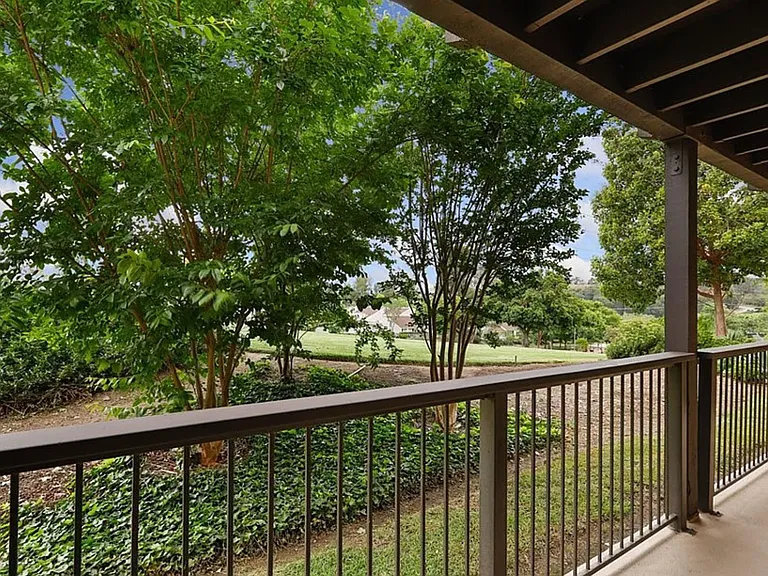 Tranquil back porch/patio overlooking the natural greenbelt.