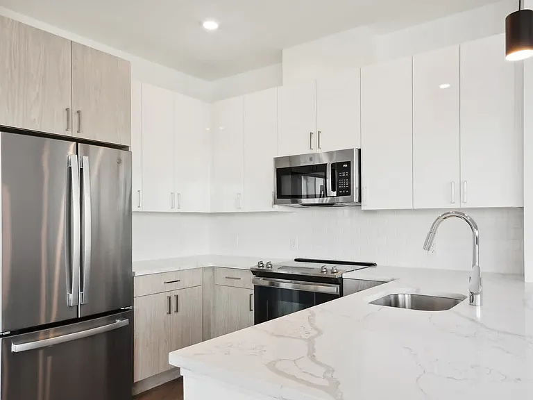 Kitchen with Stainless Steel Appliances and White Granite Countertops