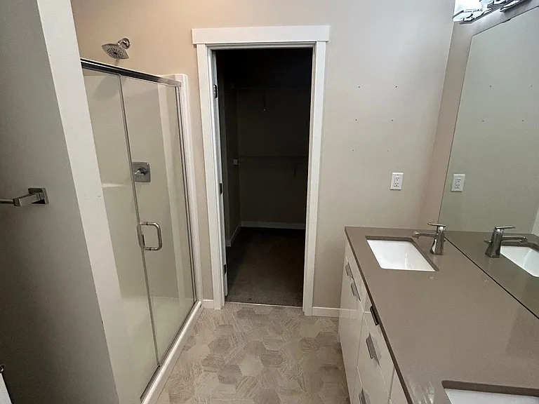 Ensuite to the primary bedroom. Walk in closet in the back.