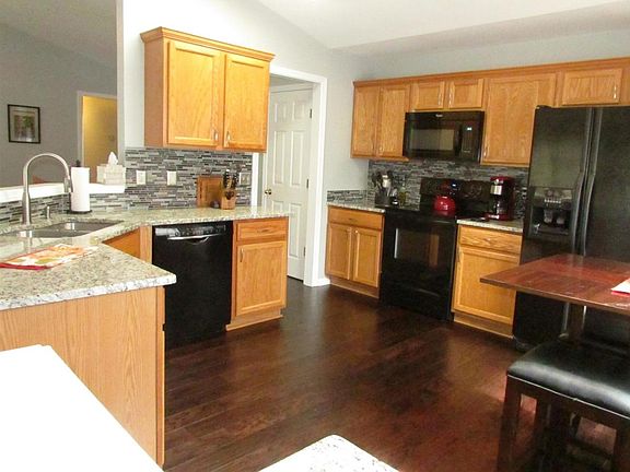 Beautifully updated kitchen with granite countertops and gla