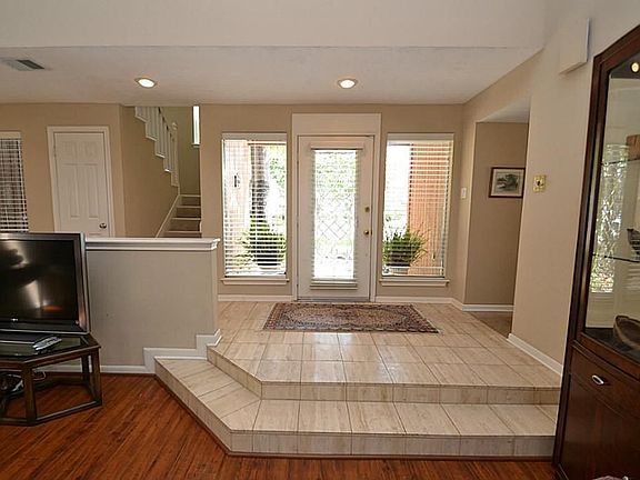 Elegant entry offering a beveled glass front door with tile flooring.