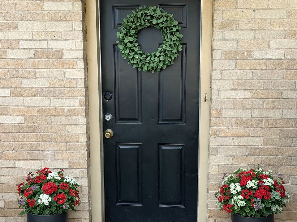 Private front door entrance behind privacy fenced patio