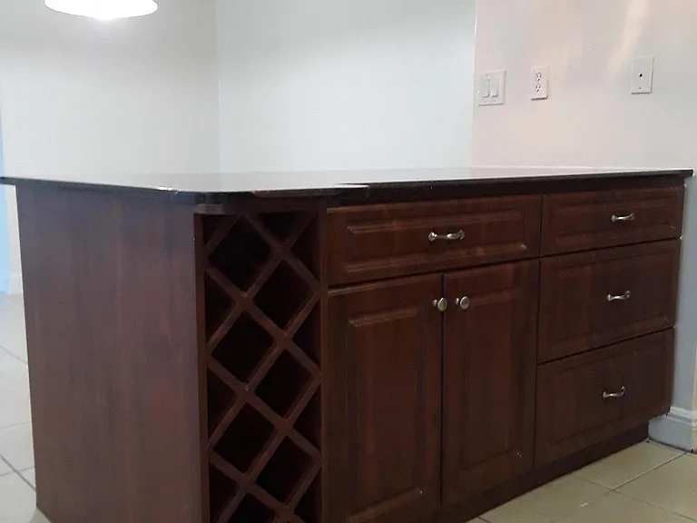 Kitchen counter with built-in rack for wine bottles, etc.