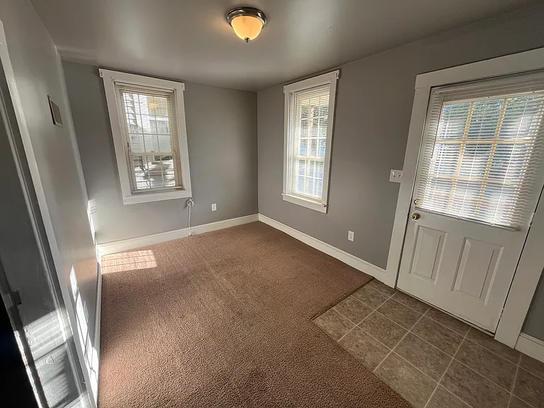 Living room, front entrance to the right, kitchen to the left.