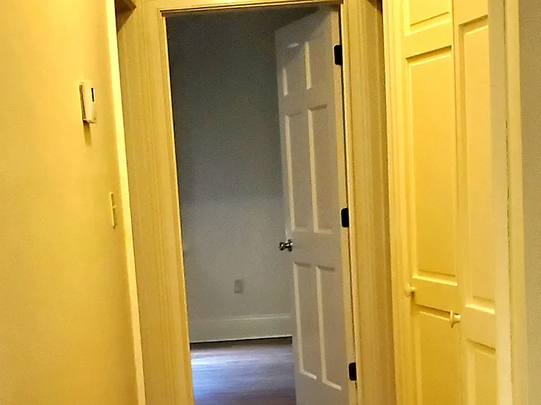 Hallway with closet leading to bedrooms
