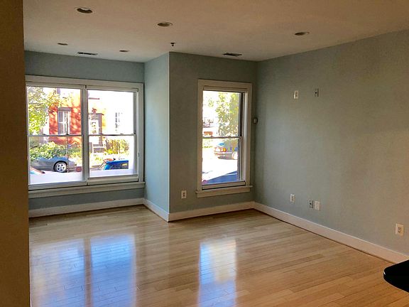This is the living room without furniture. The Hunter Douglas blinds start from the bottom up on the window sill to allow for maximum light while still providing privacy.