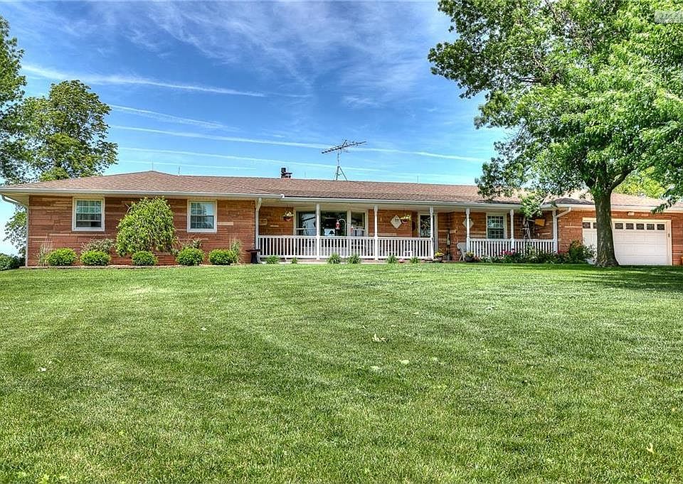 True ranch home with acreage, barns and lake!
