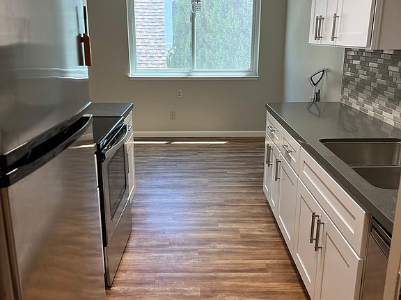 Kitchen with brand new cabinets and quartz countertops, and stainless appliances. Light-filled breakfast nook.
