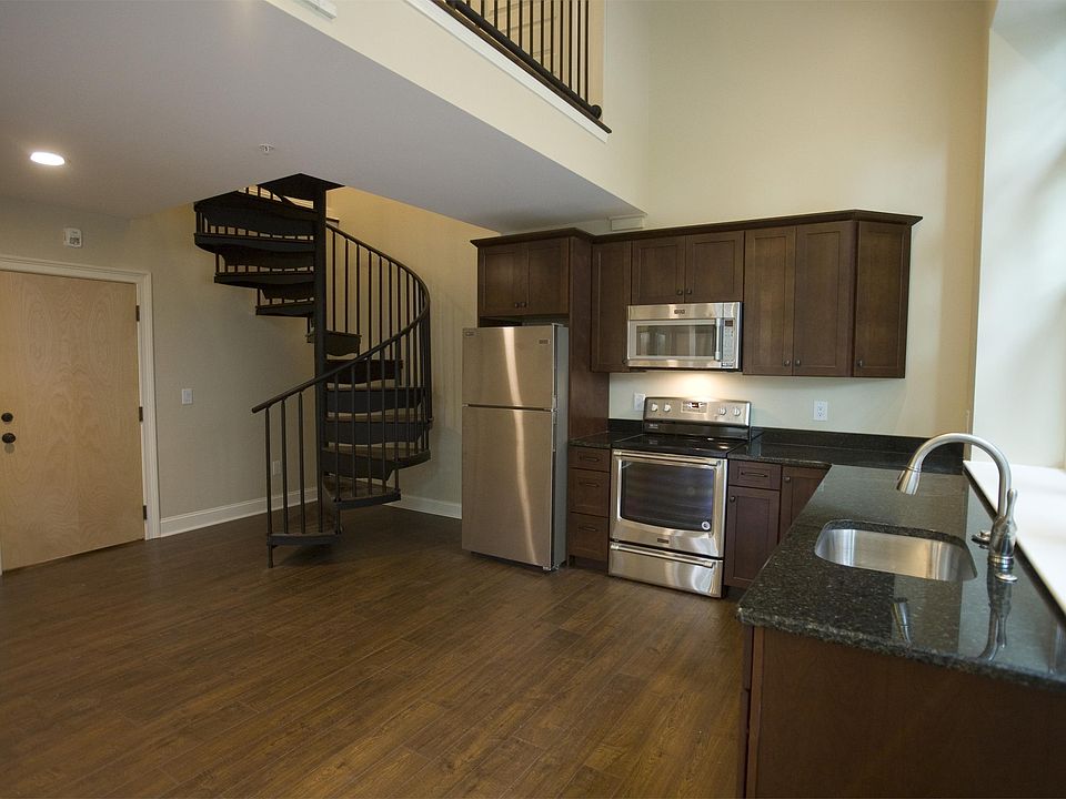 Open kitchen floor plan with spiral stairs to loft