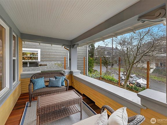 Step onto this charming covered front porch, the perfect spot to enjoy a quiet morning or unwind with a book.>